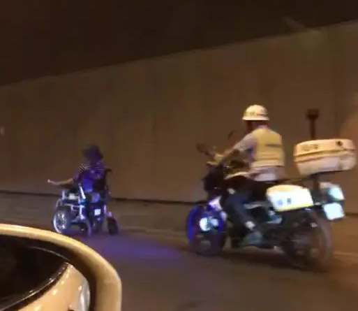 老人駕駛電動(dòng)輪椅在隧道中穿行